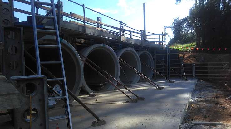 Large headwall formed around reinforced concrete pipe culverts