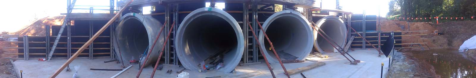 Large headwall formed around reinforced concrete pipe culverts